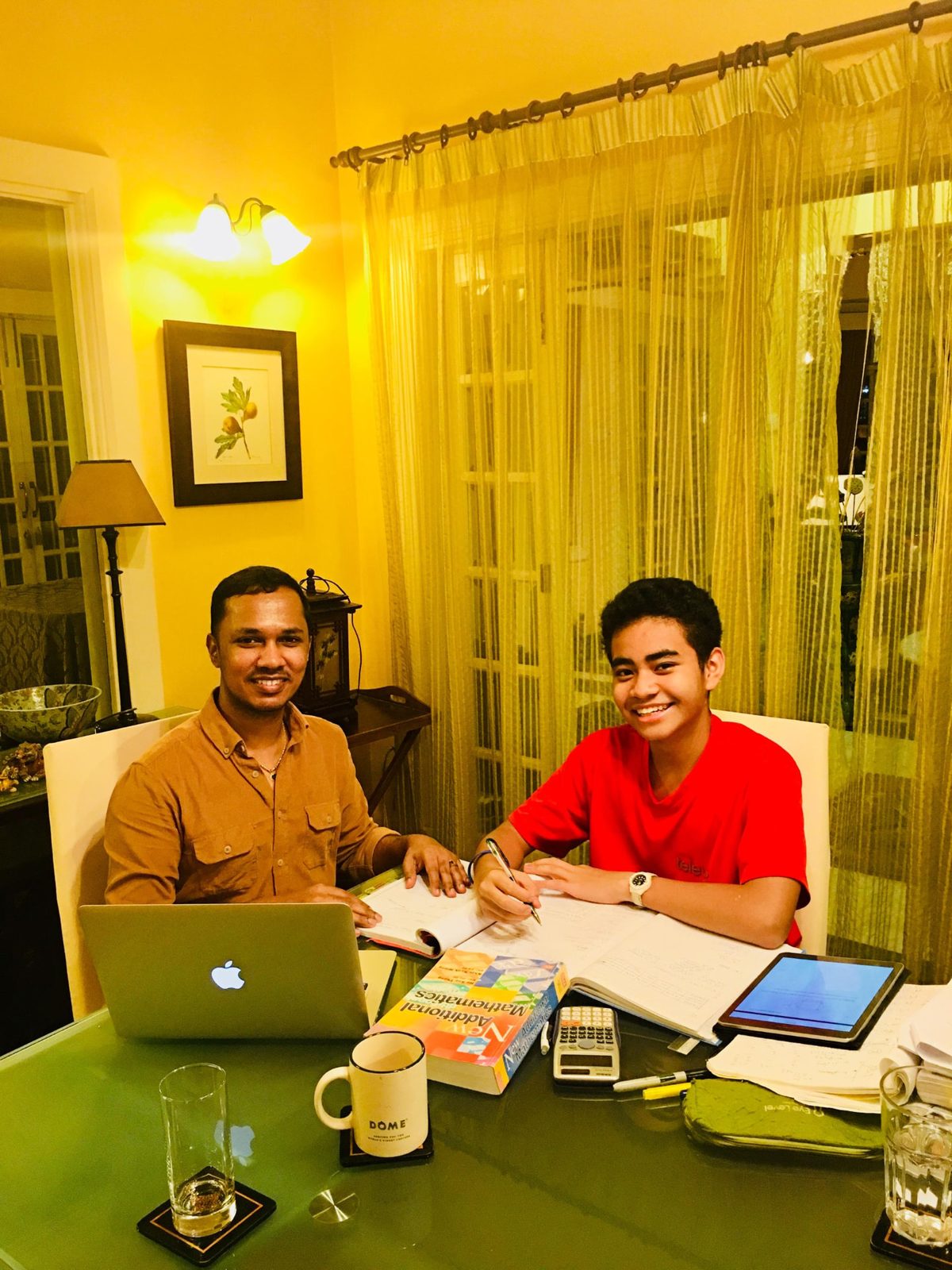 Mr Kumaraveelu and a student during a personal Mathematics lesson